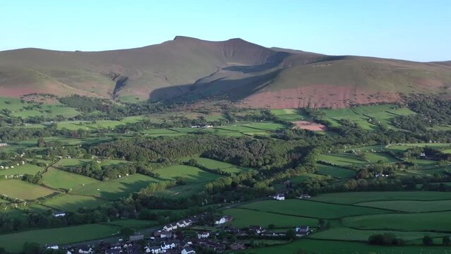 Brecon Beacons National Park now known as Bannau Brycheiniog to celebrate its 66th anniversary, showing the mountain peaks Penyfan and Corn Du and the village Libanus.