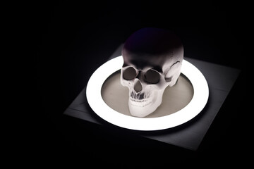 top view of a human skull illuminated from below by a round LED backlight
