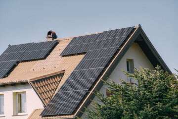 Eco-Friendly Energy Solution with Solar Panels on a Modern Residential House. Solar panels on the roof of the contemporary house. Sustainable future concept.