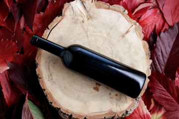 glass bottle of wine on a wooden round surface