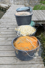 Jetty at the harbor with buckets and various fishing nets