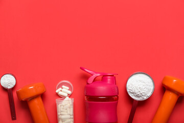Composition with bottle of water, dumbbells, amino acid pills and powder on red background