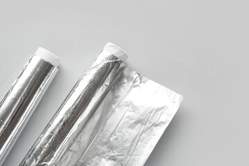 Aluminium foil rolls on grey background