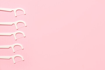 Floss toothpicks on pink background