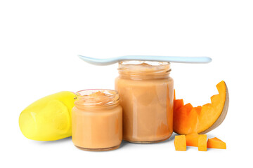 Jars of baby food, pumpkin and nibbler on white background