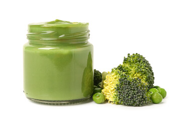 Jar of baby food and vegetables on white background