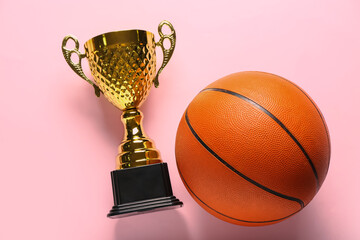Gold cup with ball on pink background
