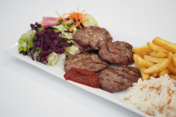 Kebab, traditional turkish meat food with salad on a plate 
