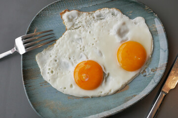 Fried eggs in the plate close up ,