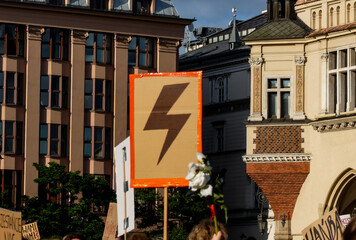 Women's Strike. People hold banners with a red lightning bolt
