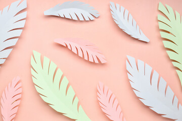 Fototapeta na wymiar Paper tropical leaves on pink background
