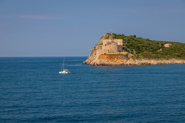 Landscape Exposure done from a cruise ship, showing the sea entrance to Kotor bay and its beautiful coastal landscapes and small villages , on a sunshiny day.