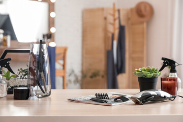 Different hairdressing tools on table in beauty salon