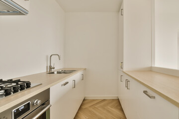Fototapeta na wymiar a kitchen with white cabinets and wood counter tops in an apartment near london, england by corbo architects