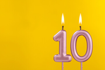 Birthday candle number 10 - Birthday celebration on yellow background