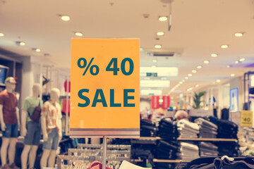 price reduction announcement on clothing store window