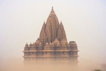 An ancient temple immersed in mist, shrouded in mystery and history, beckoning travelers to explore its sacred grounds