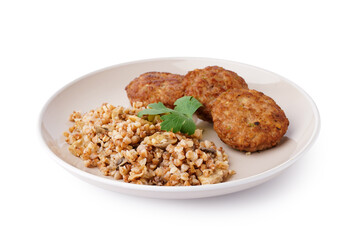 Cutlets with buckwheat, mushrooms and parsley on white background