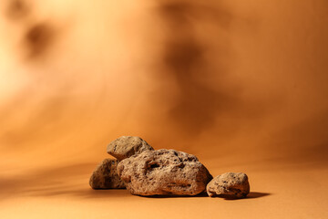 Decorative stone podiums on brown background