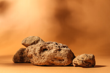 Decorative stone podiums on brown background