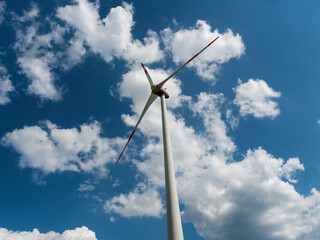 Wind Turbine Beneath the Clouds: Symbol of Renewable Energy from Sun and Wind