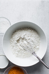 All purpose flour in a white bowl, baking flour in a large bowl