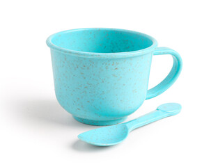 Blue cup with spoon isolated on white background. Children's Day celebration