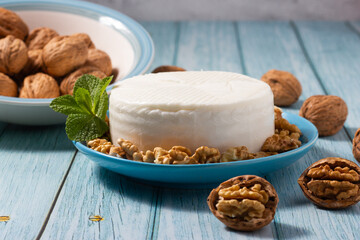 Close-up of a piece of fresh goat cheese and walnuts.