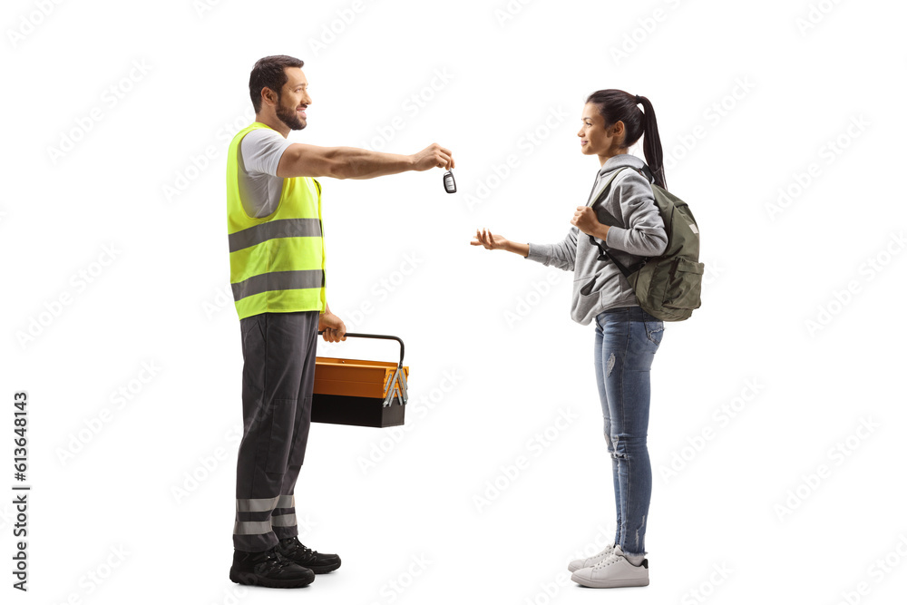 Wall mural full length profile shot of a road assistance agent giving car keys to a female student