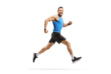 Fototapeta na wymiar Full length profile shot of a man in sportswear running and smiling