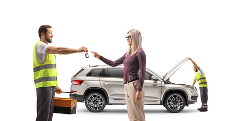 Road assistance agent giving SUV keys to a woman