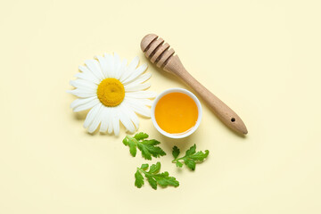 Composition with bowl of honey, dipper, chamomile flower and leaves on color background