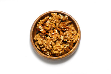 Peeled walnuts in wooden bowl isolated on white background. Top view.