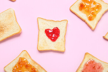 Toasts with different jams on pink background, closeup