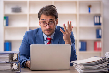 Young male employee working in the office