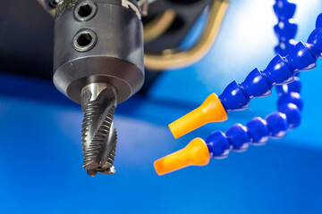 CNC milling cutter with blue cooling flexible tubes