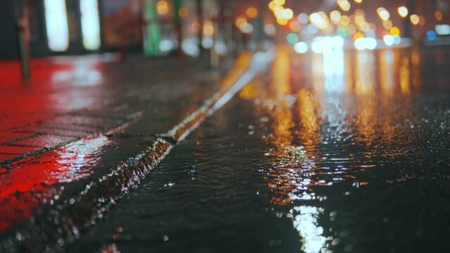 The foot of an unrecognizable person steps into a puddle, breezes fly