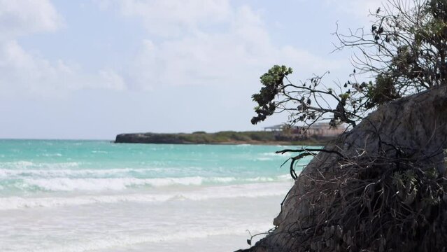 Beautiful view of the ocean.Landscape with incoming waves and coastal cliffs.Small waves wash the sandy shore. Tides, ebbs and sea level rise due to global warming.Atlantic Ocean coast in Cuba