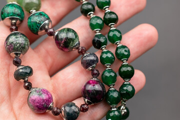 Statement green and pink stone bead necklace on black, unique handmade jewelry background, massive...