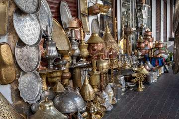 Lanterns, plates and vases in embossed metal, typical Moroccan craftsmanship under the arches of...