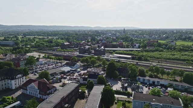 Drone shot of a neighbourhood in Minden town , a middle-sized town in the very north-east of North Rhine-Westphalia, Germany, . Flying over houses and trees .