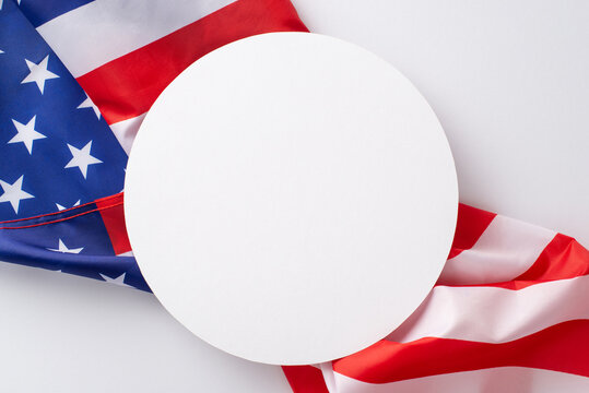 Public holiday in USA concept. High angle view photo of empty circle surrounded by the flag of United States of America on white isolated background with copy-space