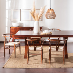 A spacious wooden dining table with four accompanying chairs, surrounded by a tasteful vase for added decor