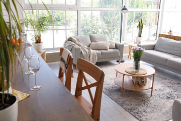 Island table with wine glasses in interior of open plan kitchen