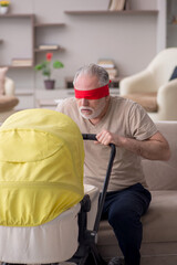 Old man looking after newborn at home