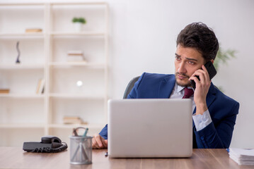 Young male employee working in the office