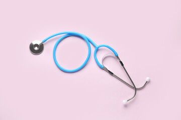 Modern stethoscope on  pink background