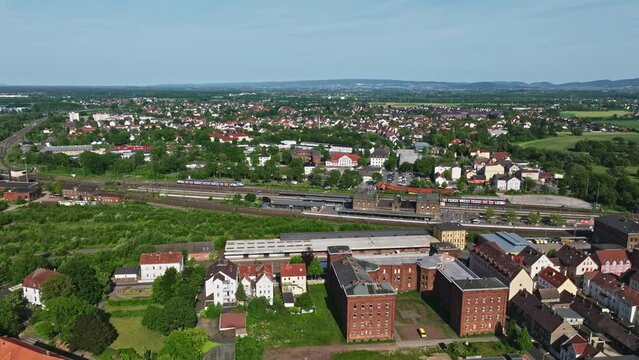 Drone shot of a neighbourhood in Minden town , a middle-sized town in the very north-east of North Rhine-Westphalia, Germany, . Flying over houses and trees .