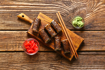 Tasty maki rolls, ginger and wasabi on wooden background © Pixel-Shot