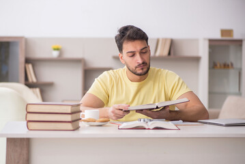 Young male student studying at home